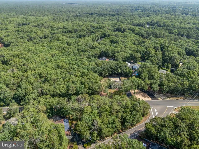 an aerial view of a house with a yard basket ball court and outdoor seating