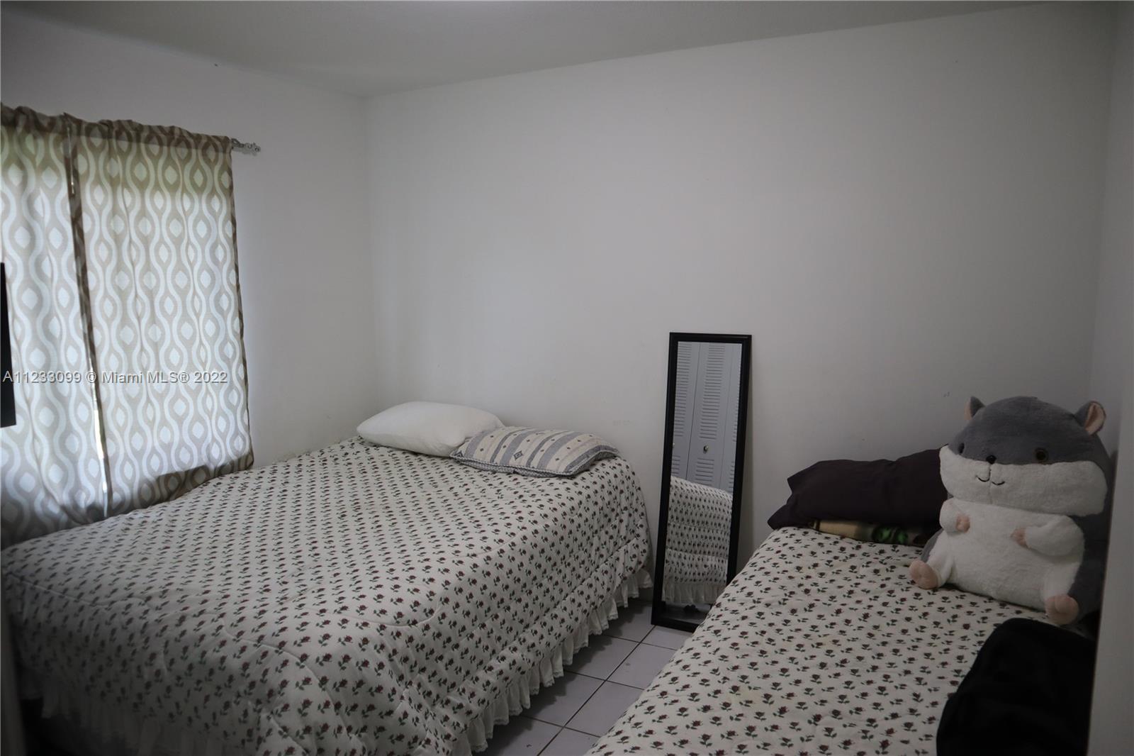 15261 Southwest 303rd Street Homestead, FL 33033 - Photo 11 of 23 a bedroom with a bed and wooden floor