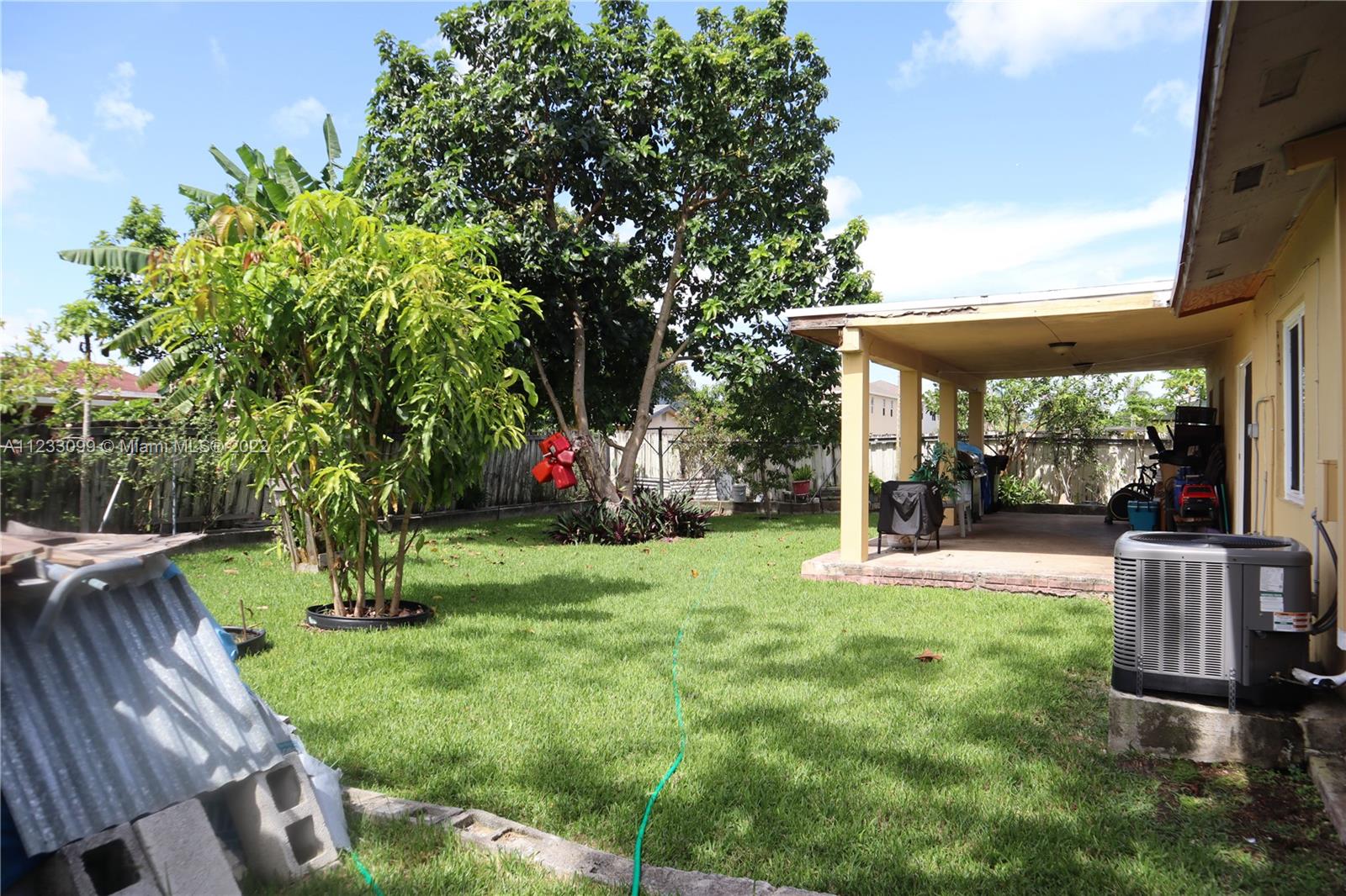 15261 Southwest 303rd Street Homestead, FL 33033 - Photo 16 of 23 a view of a backyard with garden and plants