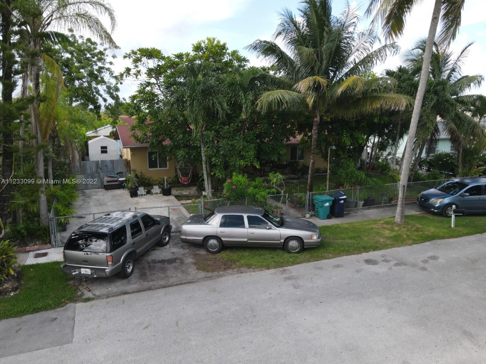 15261 Southwest 303rd Street Homestead, FL 33033 - Photo 21 of 23 a car parked in front of a house with a yard