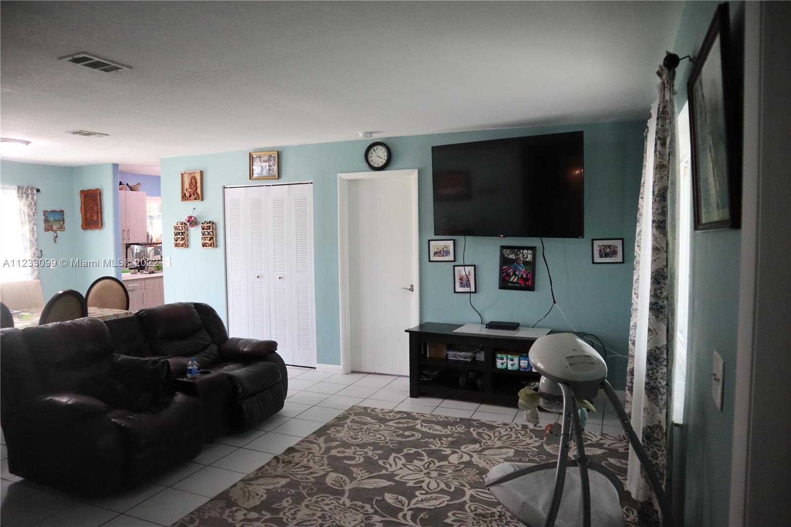 15261 Southwest 303rd Street Homestead, FL 33033 - Photo 3 of 23 a living room with furniture and a flat screen tv