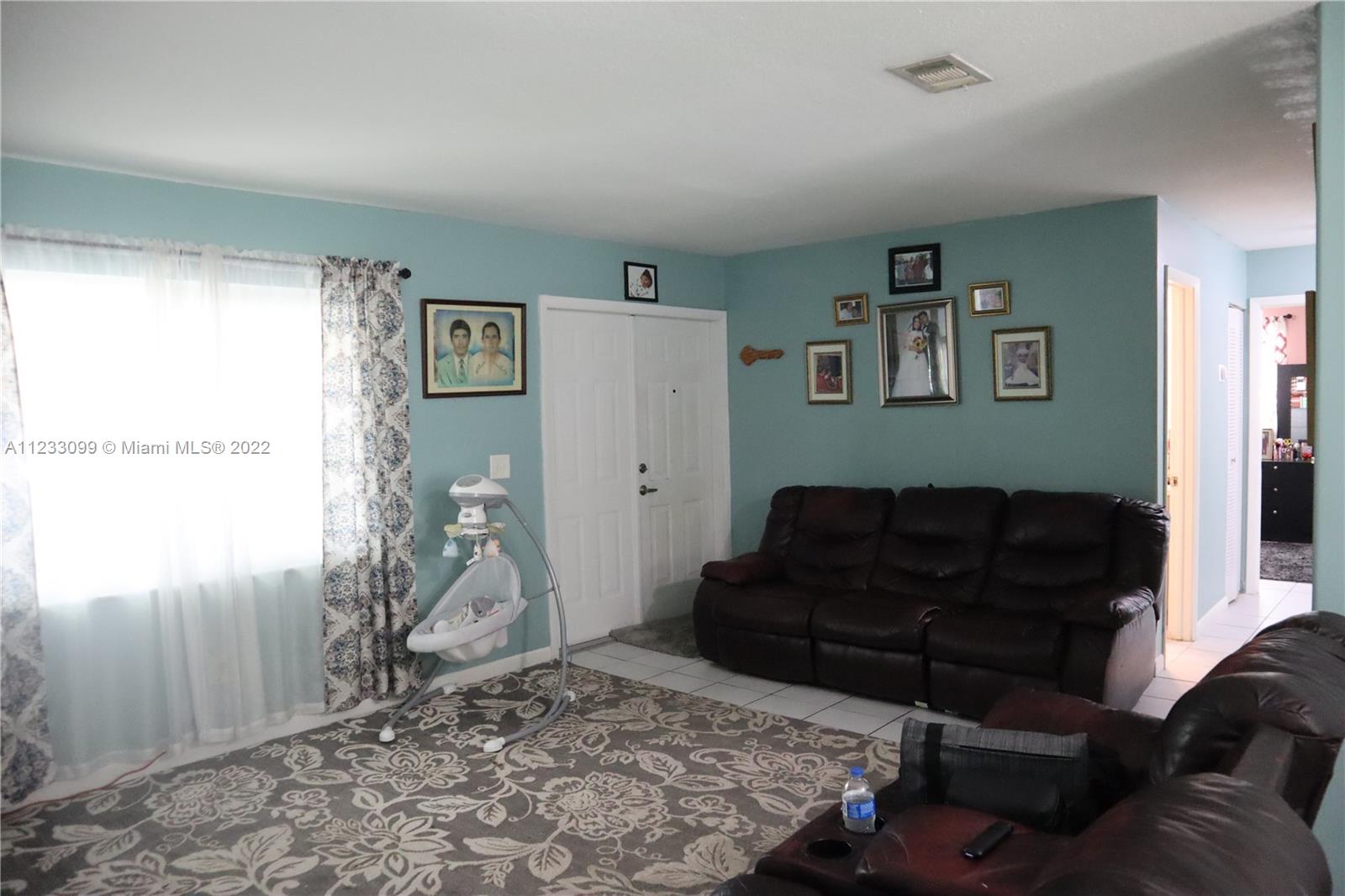 15261 Southwest 303rd Street Homestead, FL 33033 - Photo 4 of 23 a living room with furniture and a rug