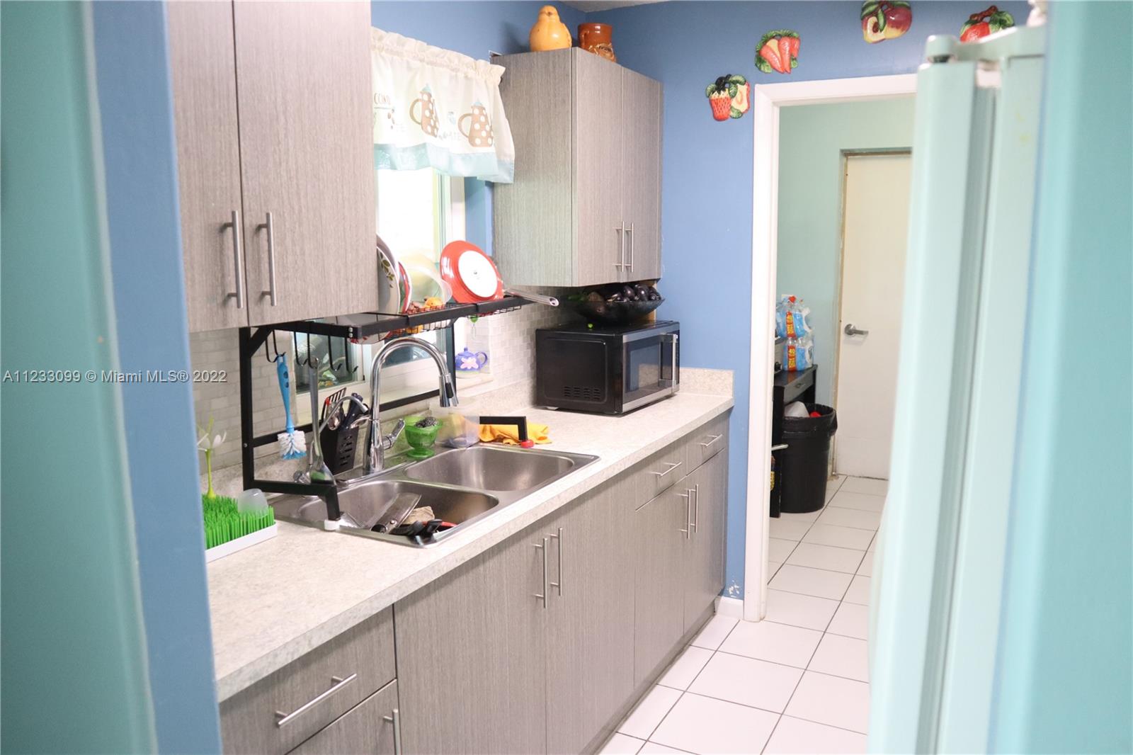 15261 Southwest 303rd Street Homestead, FL 33033 - Photo 6 of 23 a kitchen that has a sink and a stove