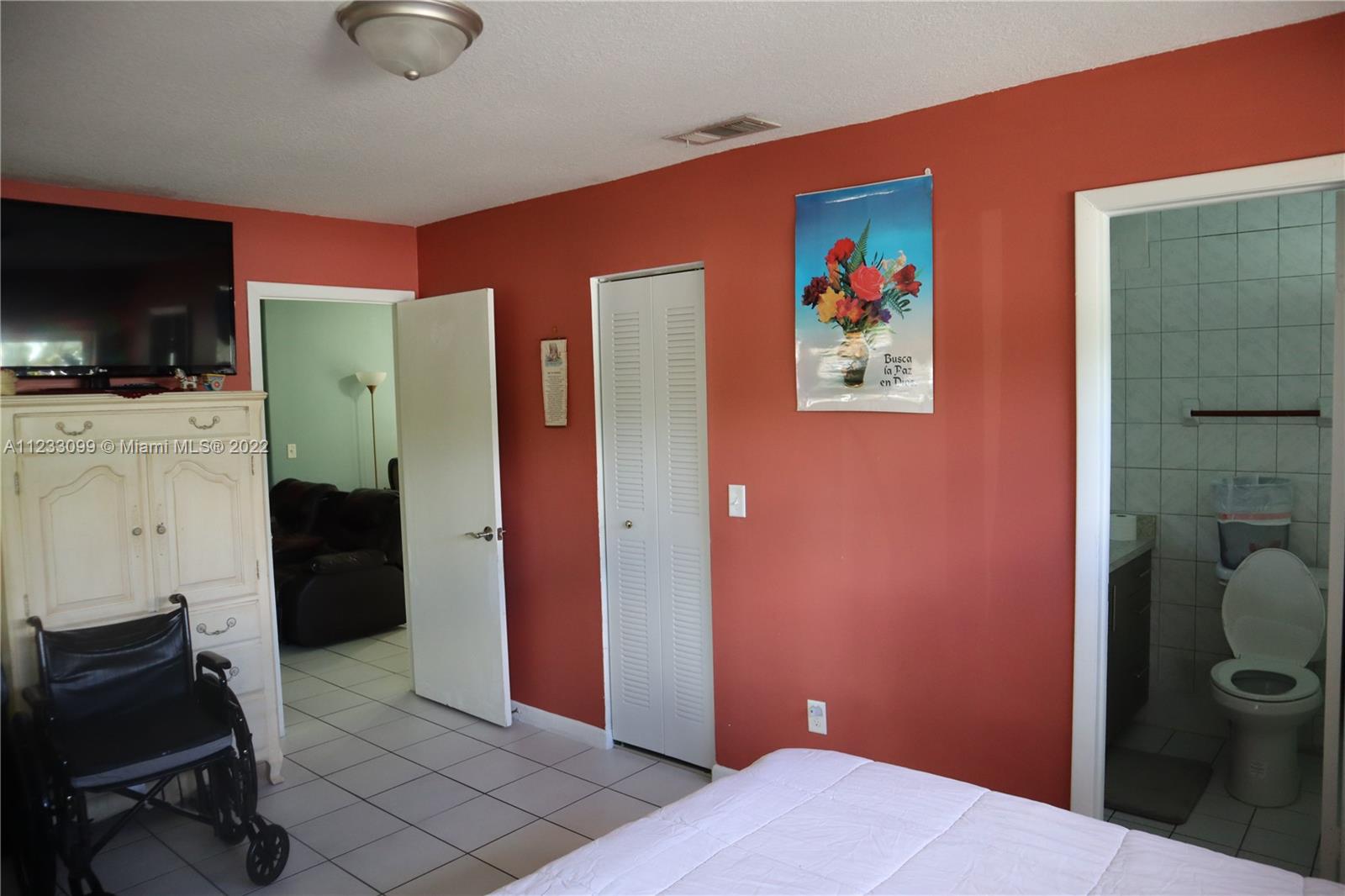 15261 Southwest 303rd Street Homestead, FL 33033 - Photo 10 of 23 a bedroom with a bed and a flat screen tv