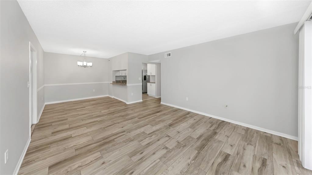 1308 Pine Ridge Circle East, Unit H1 Tarpon Springs, FL 34688 - Photo 11 of 50 a view of empty room with wooden floor