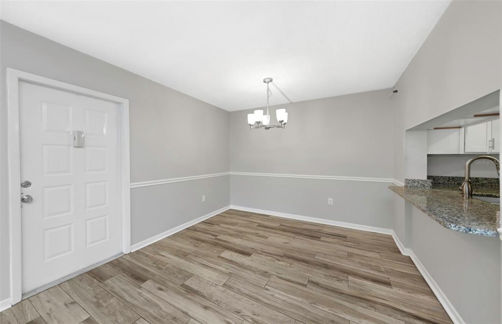 1308 Pine Ridge Circle East, Unit H1 Tarpon Springs, FL 34688 - Photo 12 of 50 wooden floor in an empty room with a window