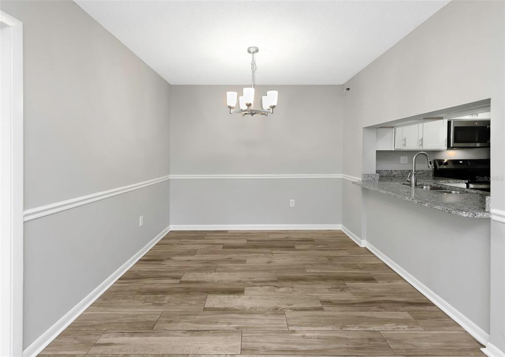 1308 Pine Ridge Circle East, Unit H1 Tarpon Springs, FL 34688 - Photo 13 of 50 a view of a kitchen with a sink and a window