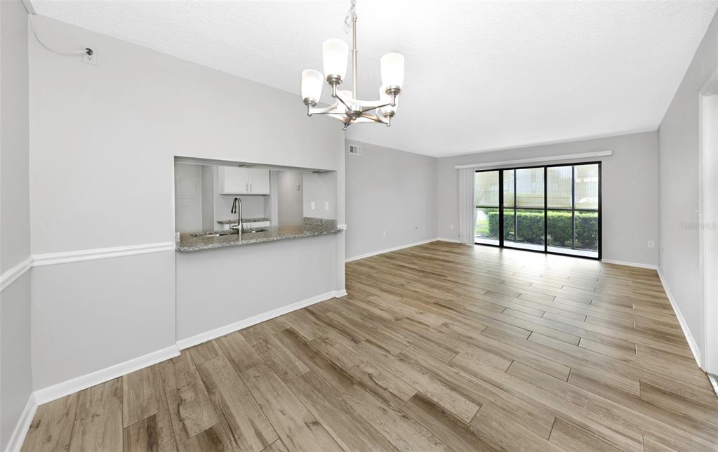 1308 Pine Ridge Circle East, Unit H1 Tarpon Springs, FL 34688 - Photo 15 of 50 wooden floor in an empty room with a window