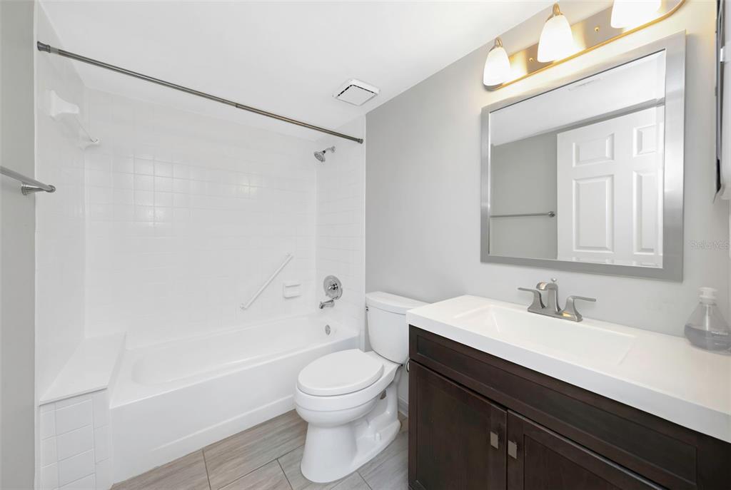 1308 Pine Ridge Circle East, Unit H1 Tarpon Springs, FL 34688 - Photo 16 of 50 a bathroom with a sink a toilet and shower