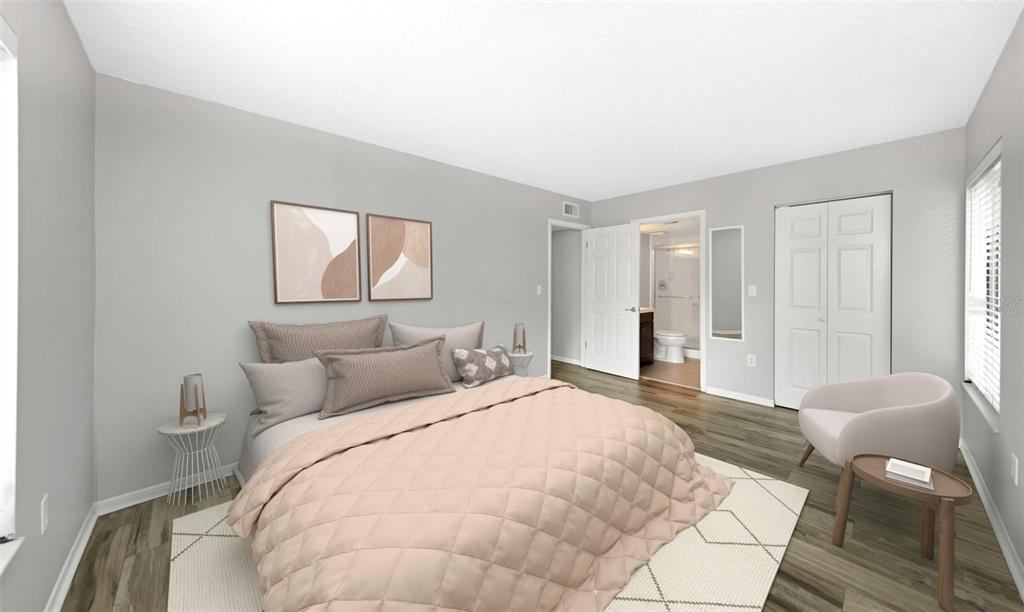 1308 Pine Ridge Circle East, Unit H1 Tarpon Springs, FL 34688 - Photo 3 of 50 a bedroom with a bed and painting on the wall