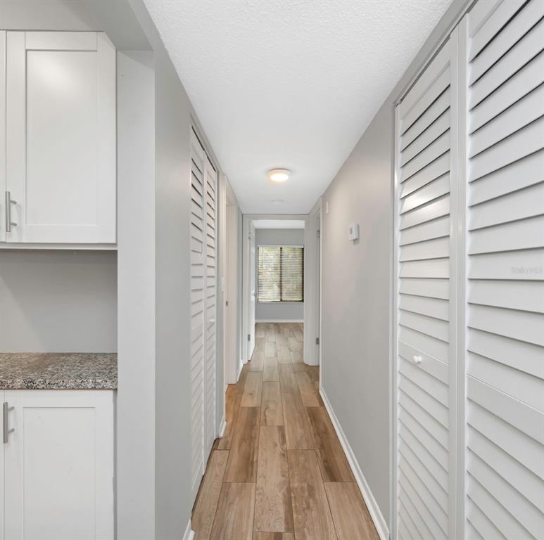 1308 Pine Ridge Circle East, Unit H1 Tarpon Springs, FL 34688 - Photo 31 of 50 a view of a hallway with wooden floor and closet