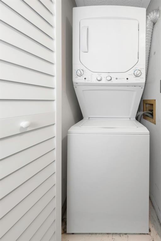 1308 Pine Ridge Circle East, Unit H1 Tarpon Springs, FL 34688 - Photo 32 of 50 a utility room with dryer and washer