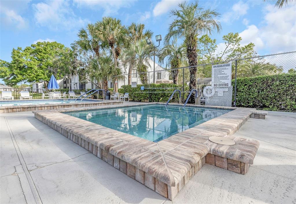 1308 Pine Ridge Circle East, Unit H1 Tarpon Springs, FL 34688 - Photo 42 of 50 a view of swimming pool with a lounge chair