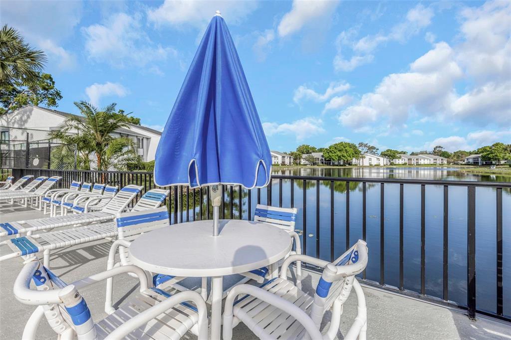 1308 Pine Ridge Circle East, Unit H1 Tarpon Springs, FL 34688 - Photo 47 of 50 a table and chairs in the patio