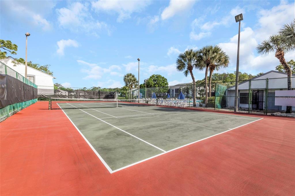 1308 Pine Ridge Circle East, Unit H1 Tarpon Springs, FL 34688 - Photo 49 of 50 a view of a tennis court
