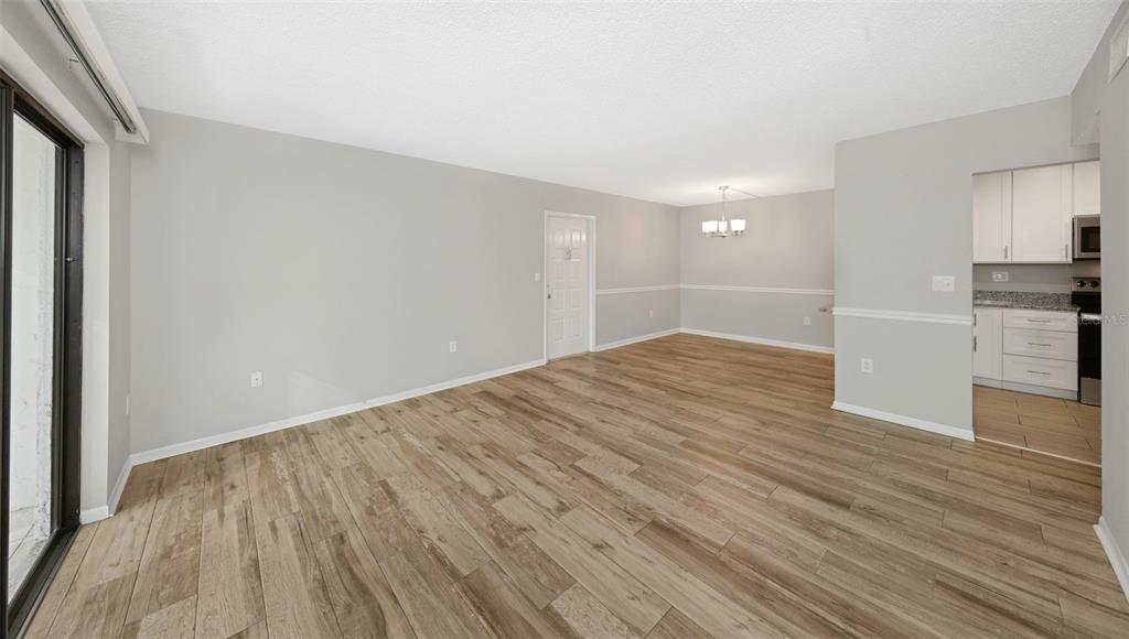 1308 Pine Ridge Circle East, Unit H1 Tarpon Springs, FL 34688 - Photo 10 of 50 a view of empty room with wooden floor