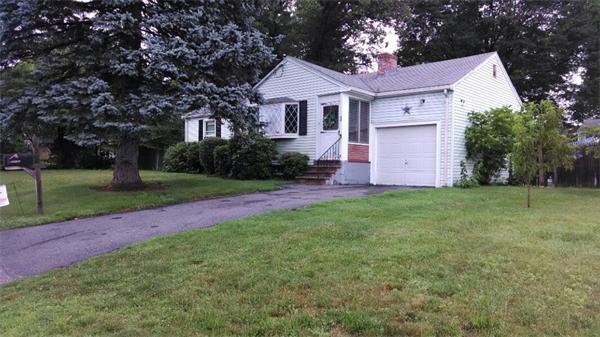 a front view of a house with yard and green space