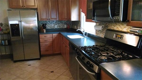 69 Ardmore Road Framingham, MA 01702 - Photo 12 of 30 a kitchen with stainless steel appliances granite countertop a stove and a refrigerator