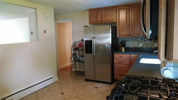 69 Ardmore Road Framingham, MA 01702 - Photo 13 of 30 a kitchen with a refrigerator and a stove top oven