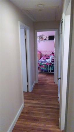 69 Ardmore Road Framingham, MA 01702 - Photo 15 of 30 a view of a hallway with wooden floor and a bedroom