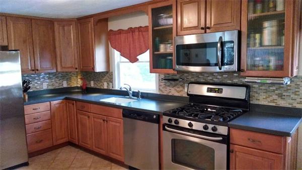 69 Ardmore Road Framingham, MA 01702 - Photo 8 of 30 a kitchen with stainless steel appliances a stove a sink and a microwave