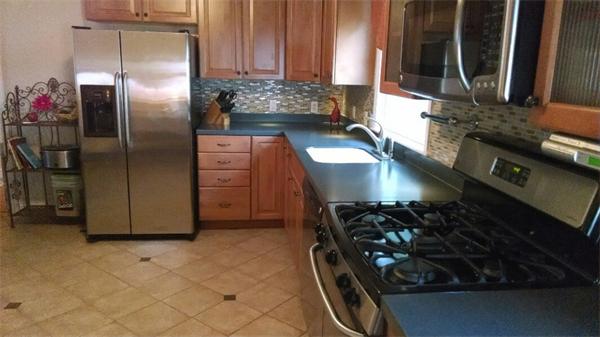 69 Ardmore Road Framingham, MA 01702 - Photo 9 of 30 a kitchen with stainless steel appliances granite countertop a sink stove and refrigerator