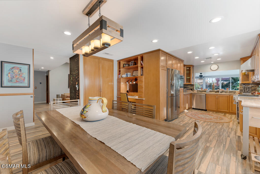 24 Kanan Road Oak Park, CA 91377 - Photo 9 of 20 a kitchen with stainless steel appliances kitchen island granite countertop a refrigerator and microwave