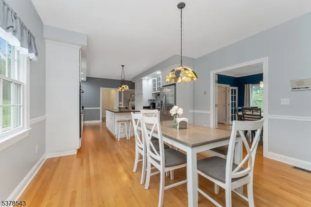 a living room with furniture a fireplace and a chandelier