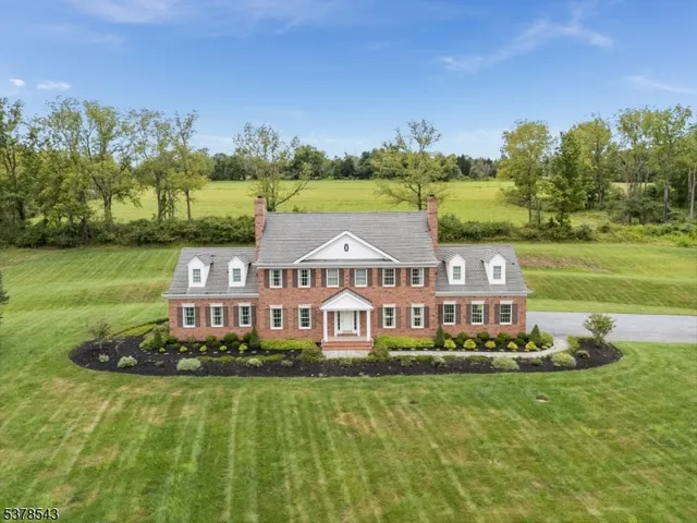 an aerial view of a house with a big yard