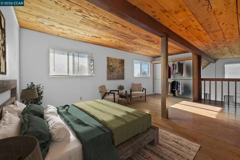 a bed sitting in a bedroom next to a window