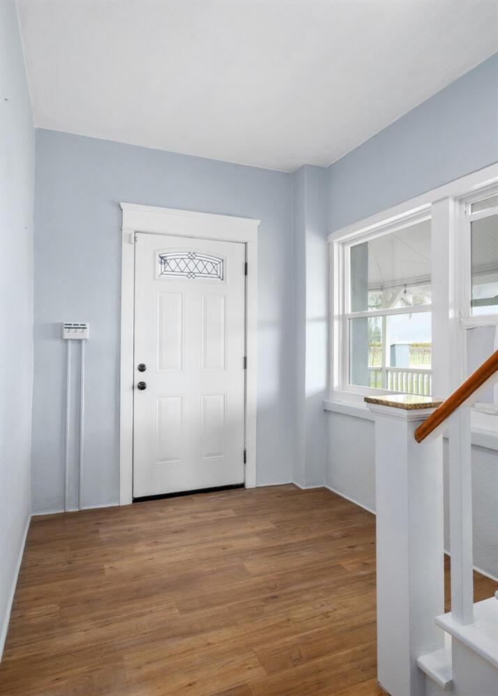 5804 Ave 426 Reedley, CA 93654 - Photo 3 of 21 a view of an empty room with wooden floor and a window