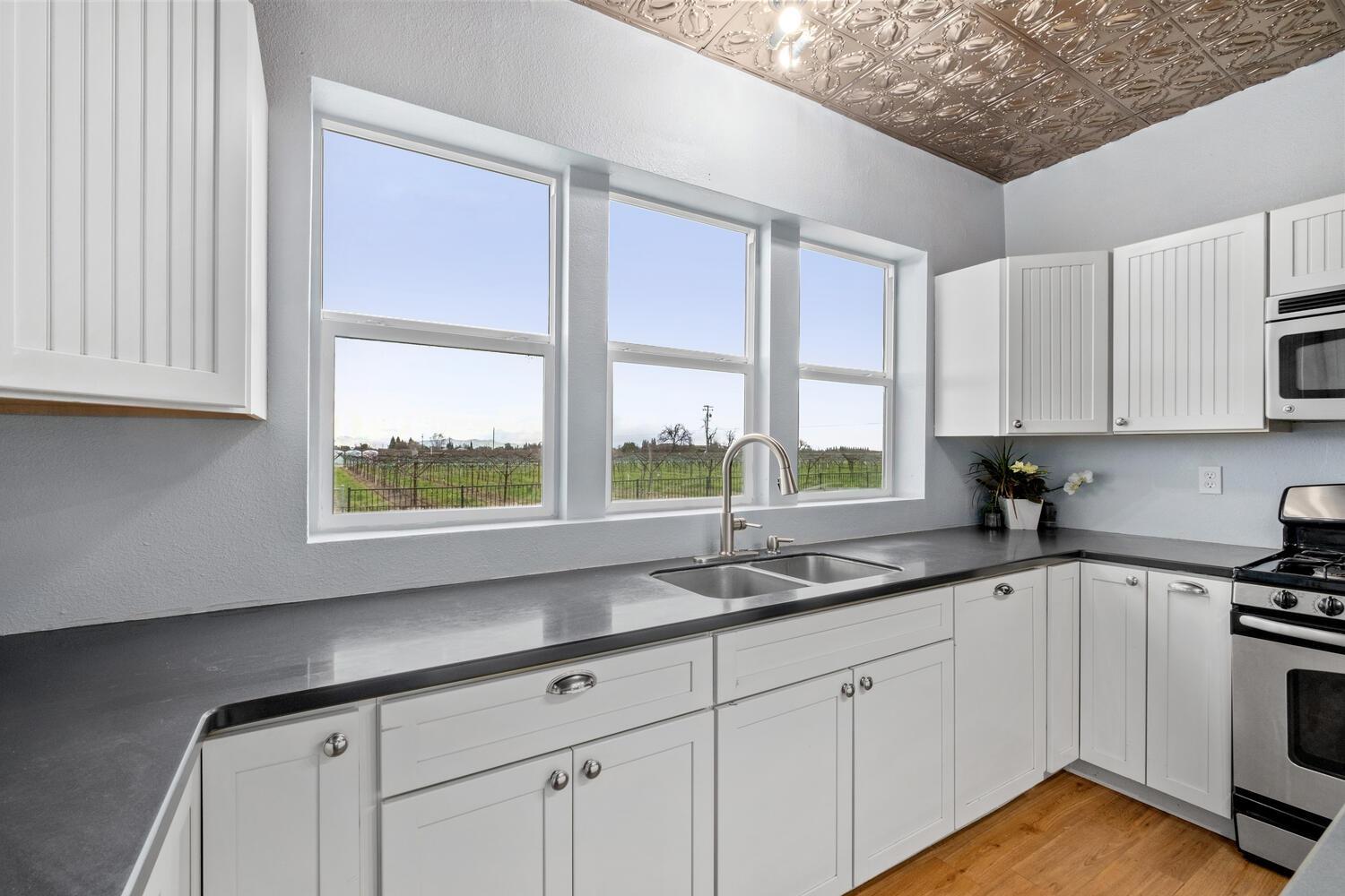 5804 Ave 426 Reedley, CA 93654 - Photo 9 of 21 a kitchen with stainless steel appliances white cabinets and a sink