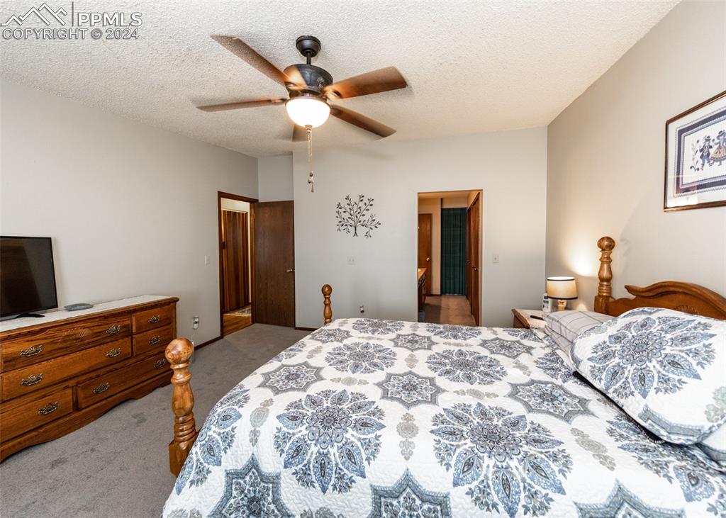 922 Fontmore Road, Unit D Colorado Springs, CO 80904 - Photo 29 of 44 a bedroom with a bed and a chandelier