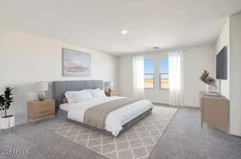 a spacious bedroom with a balcony a bed and a couch