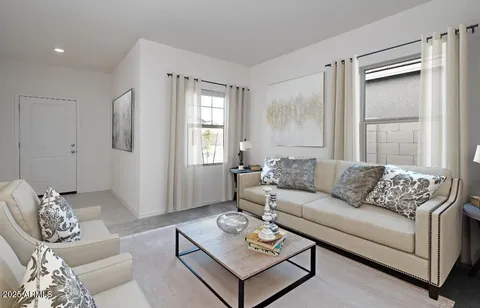 a living room with furniture and a large window