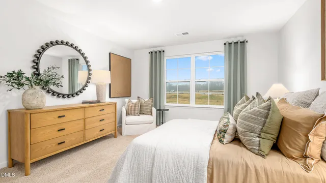 a bedroom with a bed and a large window