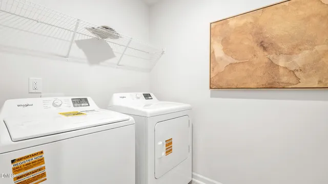 a bedroom with a bed and painting on the wall