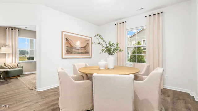 a dining room with furniture and wooden floor