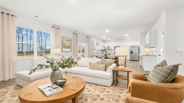 a living room with furniture kitchen view and a table