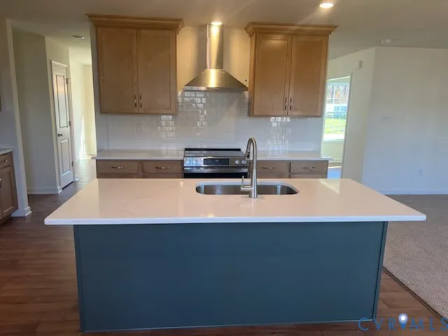 a large kitchen with kitchen island a sink a stove a oven a dining table and chairs