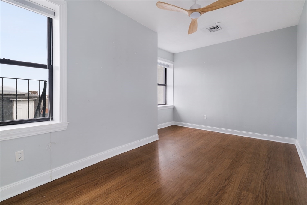 188 North Street, Unit 64 Boston, MA 02113 - Photo 11 of 27 an empty room with wooden floor and windows