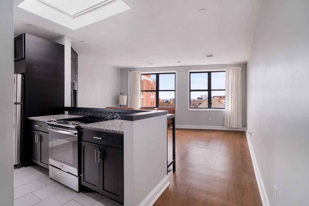 188 North Street, Unit 64 Boston, MA 02113 - Photo 12 of 27 a kitchen with a stove and a window