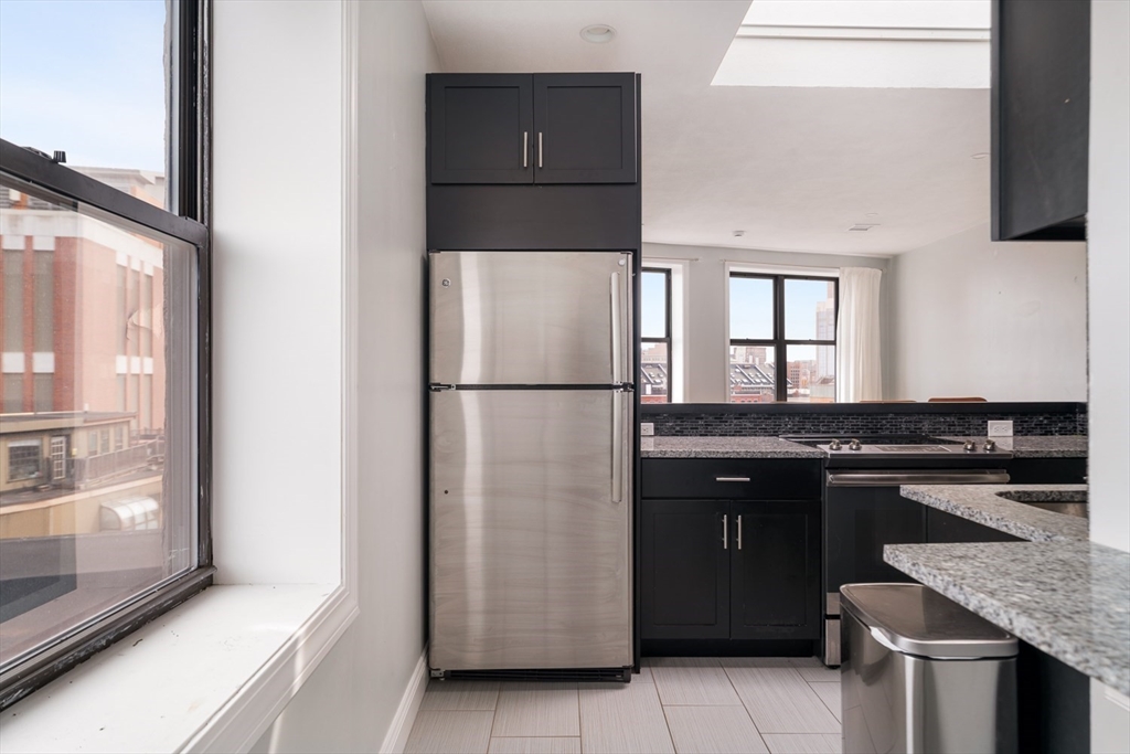 188 North Street, Unit 64 Boston, MA 02113 - Photo 15 of 27 a kitchen with a refrigerator and a sink