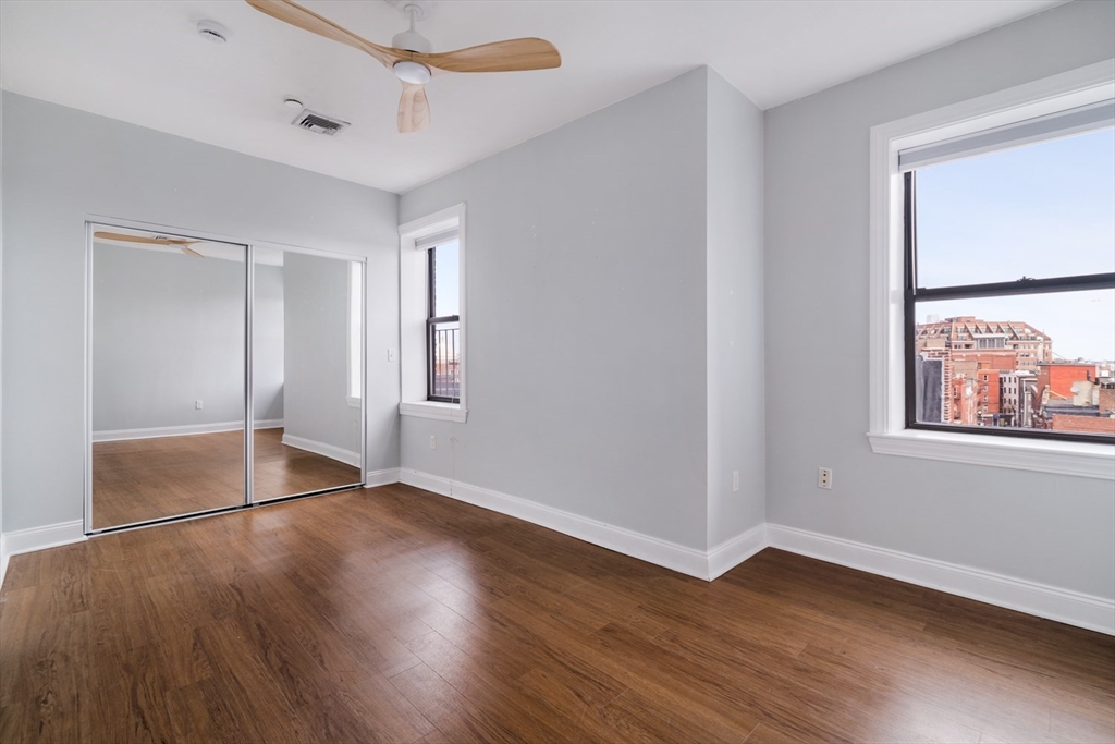 188 North Street, Unit 64 Boston, MA 02113 - Photo 8 of 27 an empty room with wooden floor and windows