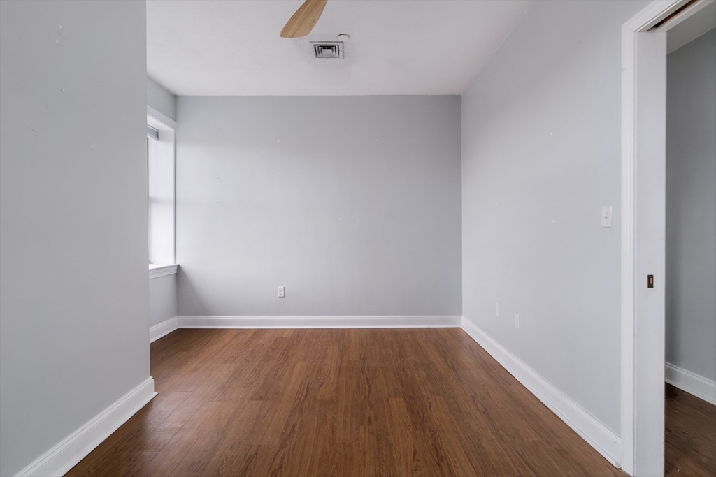 188 North Street, Unit 64 Boston, MA 02113 - Photo 9 of 27 an empty room with wooden floor and windows