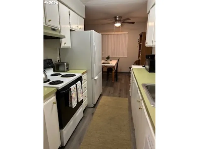 a kitchen with stainless steel appliances a refrigerator a stove and a microwave