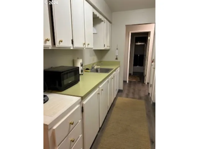 a kitchen with a sink and cabinets