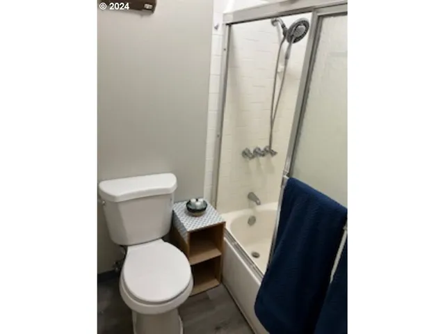 a white toilet sitting next to a small sink