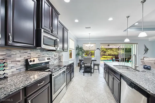 a dining room with furniture a rug and a chandelier