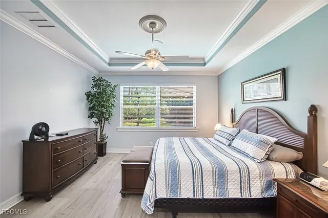a view of a hallway with wooden floor and a bathroom